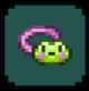 An item which appears to be a frog's face on a purple ribbon, equipped in a social accessory slot.